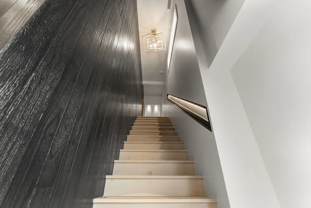 Textured black stone running the full stair height, Cherry Hills Village residence