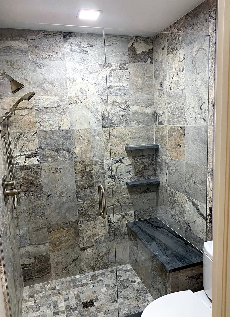 Marble shower: natural stone with a floating bench